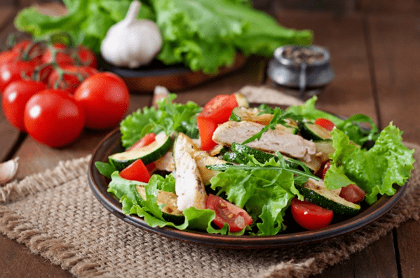 A salad with chicken and vegetables is a great choice for a light dinner after a workout. 